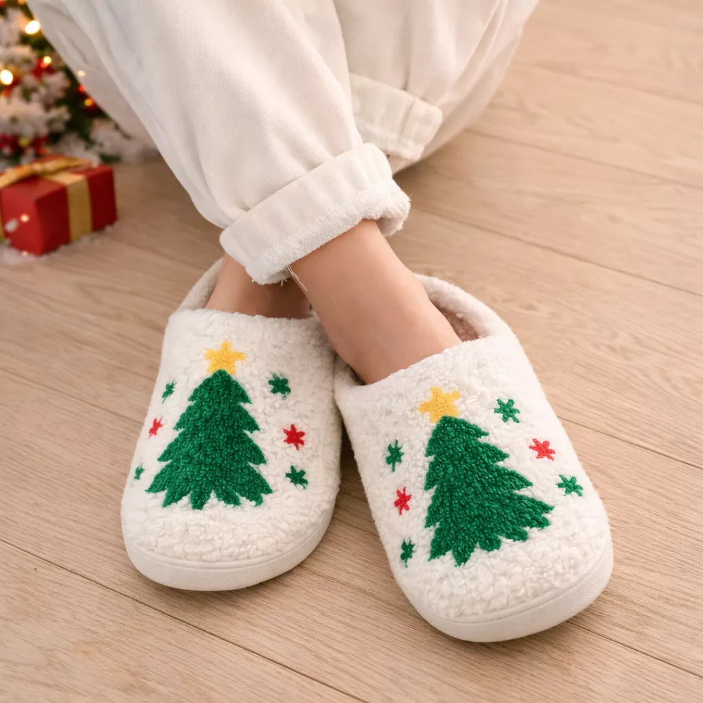 Christmas slippers with Christmas tree designs worn indoors, festive background.