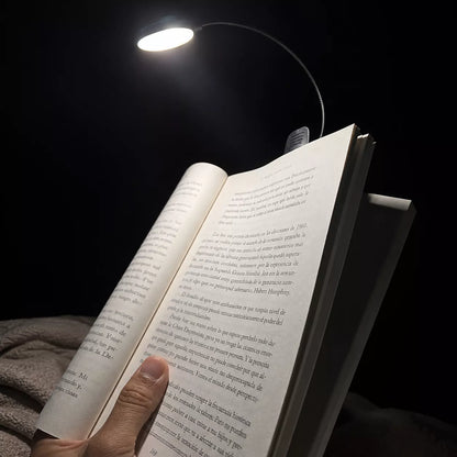 Book light illuminating the pages of an open book