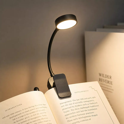Book light illuminating the pages of an open book