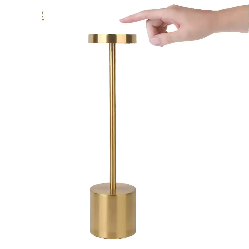 Gold rechargebale table lamp with modern round metal design. 