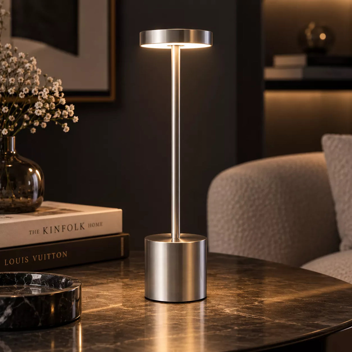 Elegant close-up of cordless rechargeable lamp glowing against a dark luxury interior