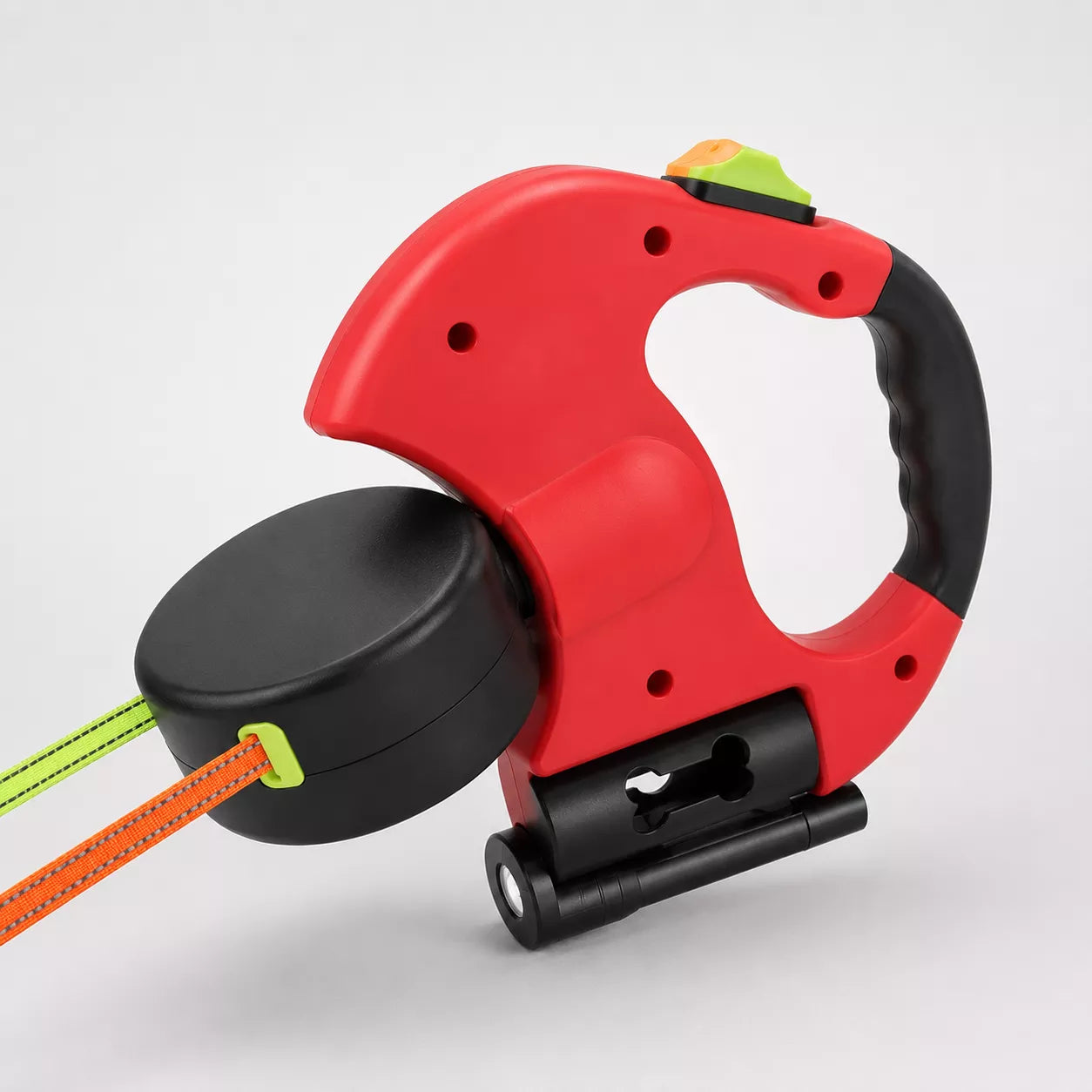 Close-up of dual dog leash handle showing color-coded brake buttons and 360-degree swivel detail