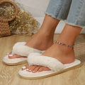 a pair of white fluffy thong slippers