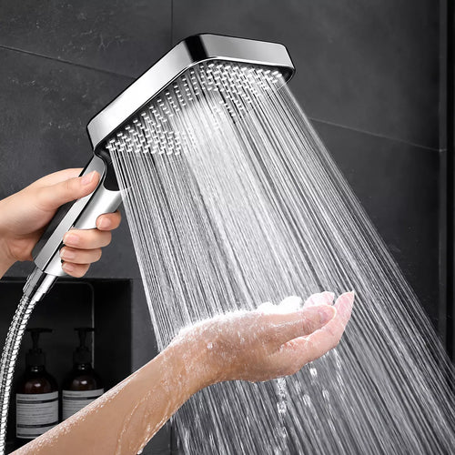 High pressure shower head spraying water in a bathroom shower
