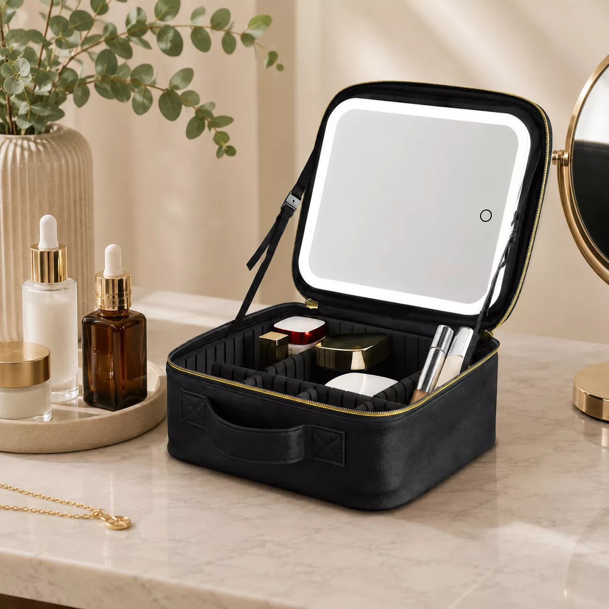 Makeup bag with detachable LED mirror positioned on a vanity beside organized cosmetics