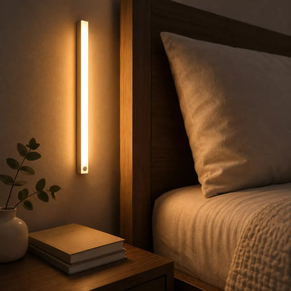 Slim rechargeable motion sensor light bar mounted to bedroom wall